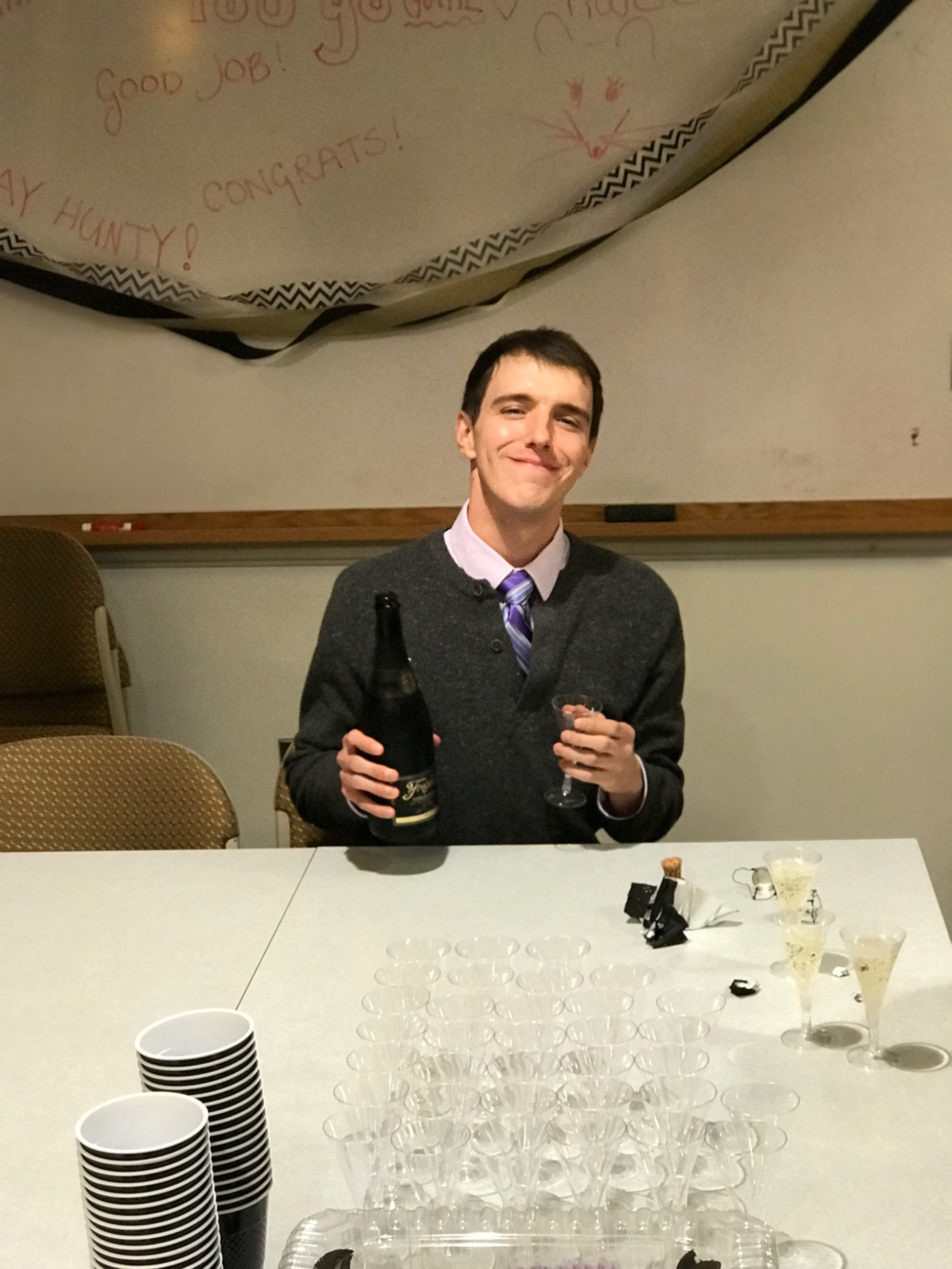 Ben smiling with champagne